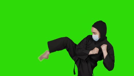 video of woman in black costume ninja on isolated green background