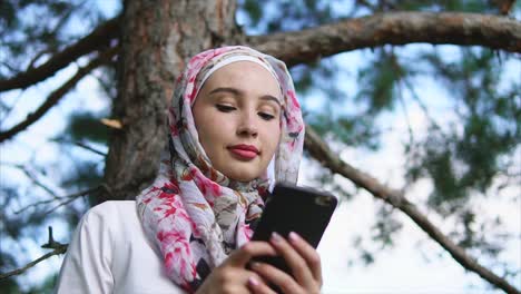 mujer usando un teléfono inteligente en un parque