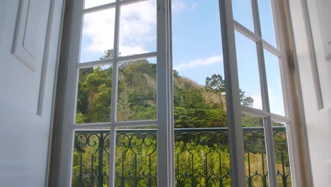 Forest-landscape-and-white-door-to-a-balcony-closes