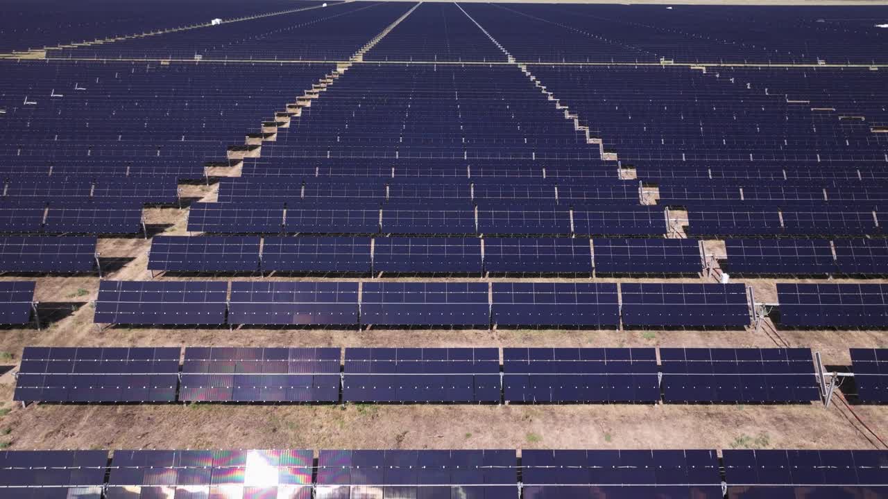 Large-scale solar farm with endless rows of photovoltaic panels