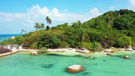 paradise calm bay with turquoise lagoon washing limestone cliffs on shore of tropical island with palm trees forest in koh phangan, thailand