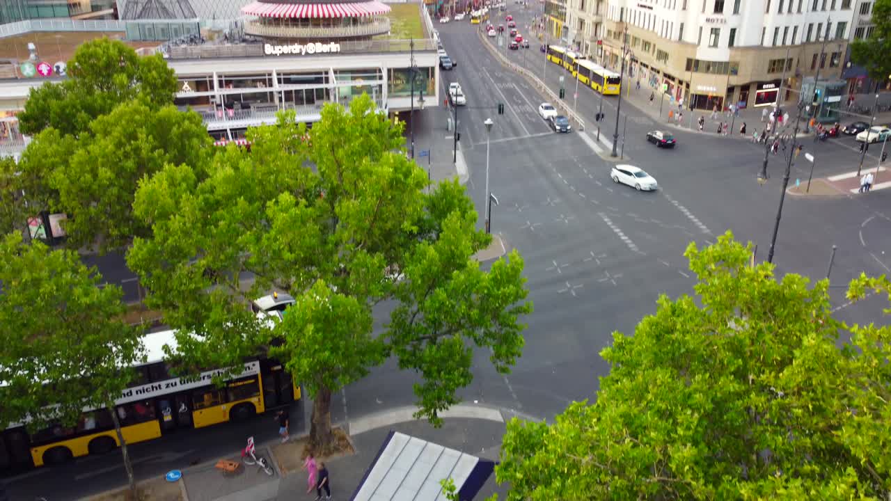 Subway entrance, shopping street intersection.Gorgeous aerial view flight tilt up drone of Kurfürstendamm Berlin germany at summer day sunset July 2022. Marnitz 4k Cinematic from above