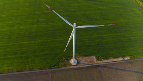 windmill farm generating green power. view of windmill rotating in rural area.