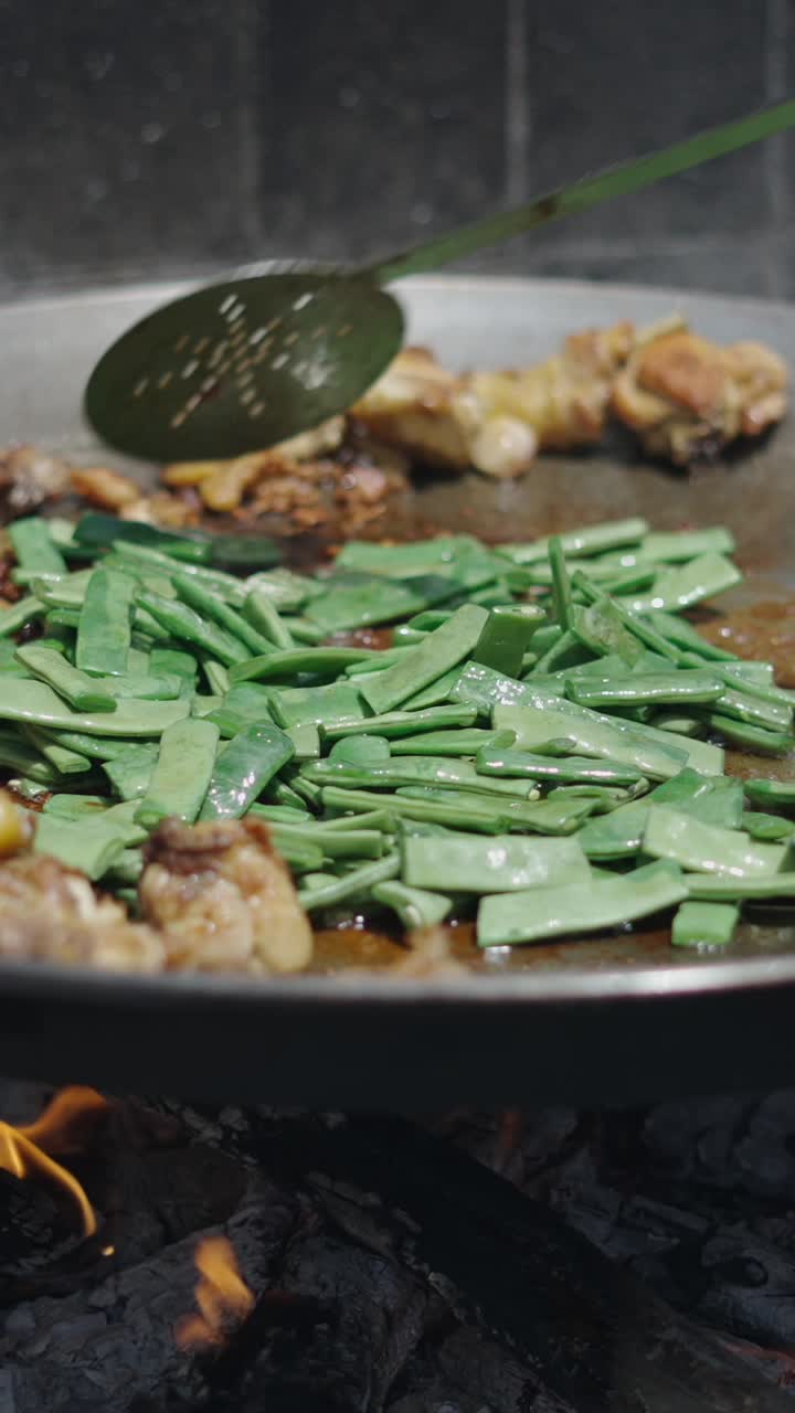Paella cooking over fire