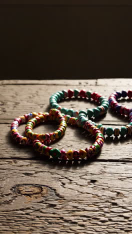 colorful beaded bracelets on wooden table