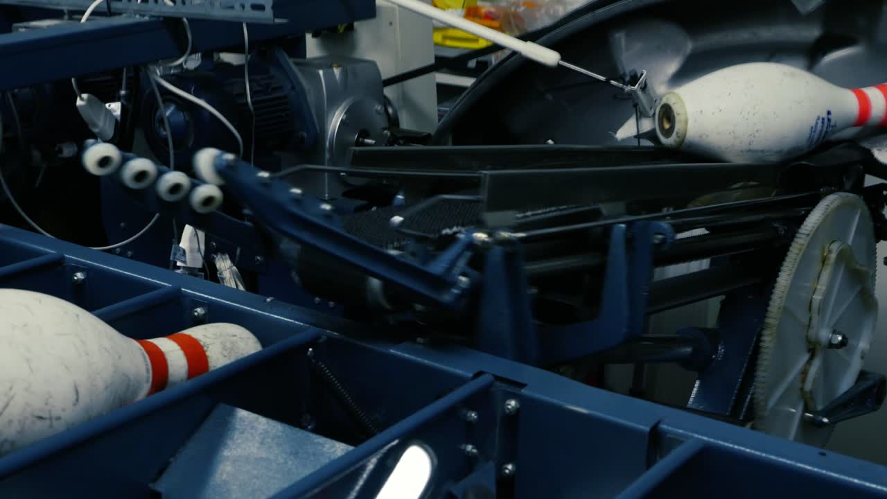 Closeup of bowling pins resetting in a pinsetter machine