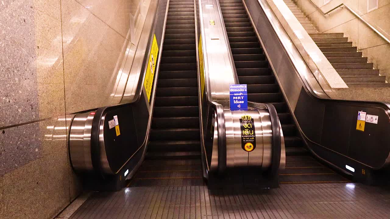 A sequence of escalator rides in a Bangkok MRT station, highlighting modern architecture and ambient lighting