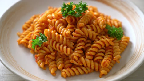 spiral or spirali pasta with tomato sauce and parsley - italian food style