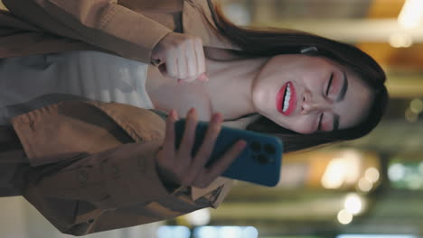happy woman using smartphone at night