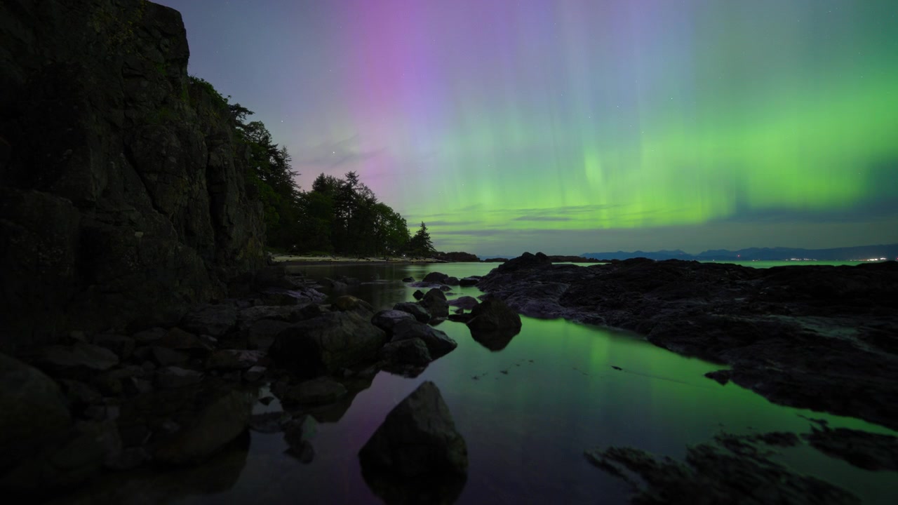 Timelapse di luci colorate dell'Aurora Boreale che danzano vicino alla costa dell'Isola di Vancouver