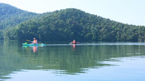 group of kayakers paddling on a calm lake