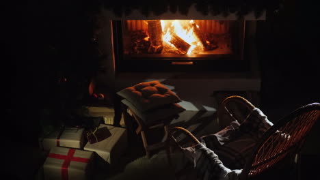 A-Rocking-Chair-Stands-By-The-Fireplace-Where-The-Flame-Burns-A-Place-For-A-Good-Time-In-Winter-Top-