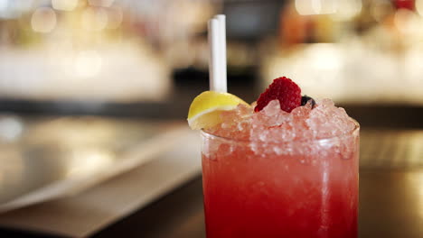 Close-Up-Of-Cocktail-Decorated-With-Fresh-Fruit-On-Bar-Counter