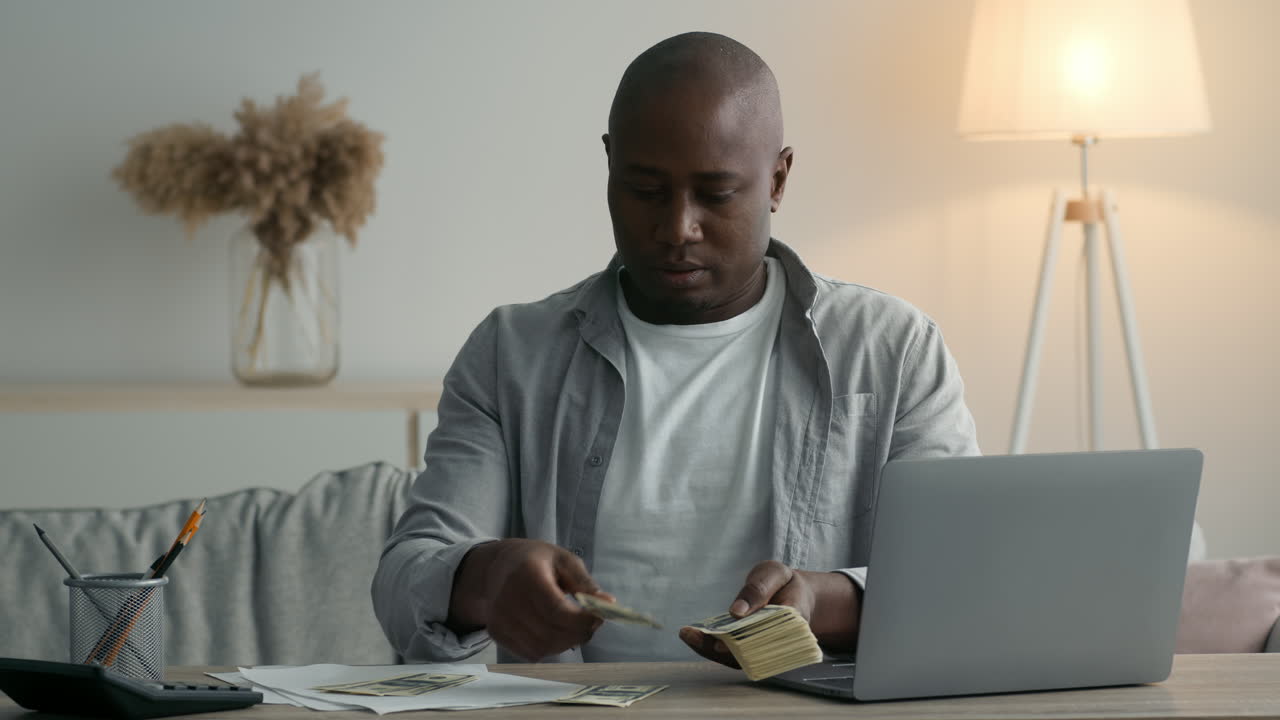 Man Counting Money at Home Office