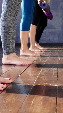 women rolling out yoga mats