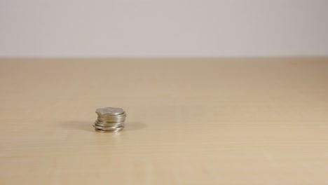 stacks of coins being piled up on table to be counted, saving money concept