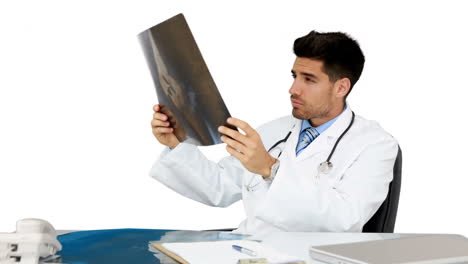 Young-doctor-working-at-his-desk