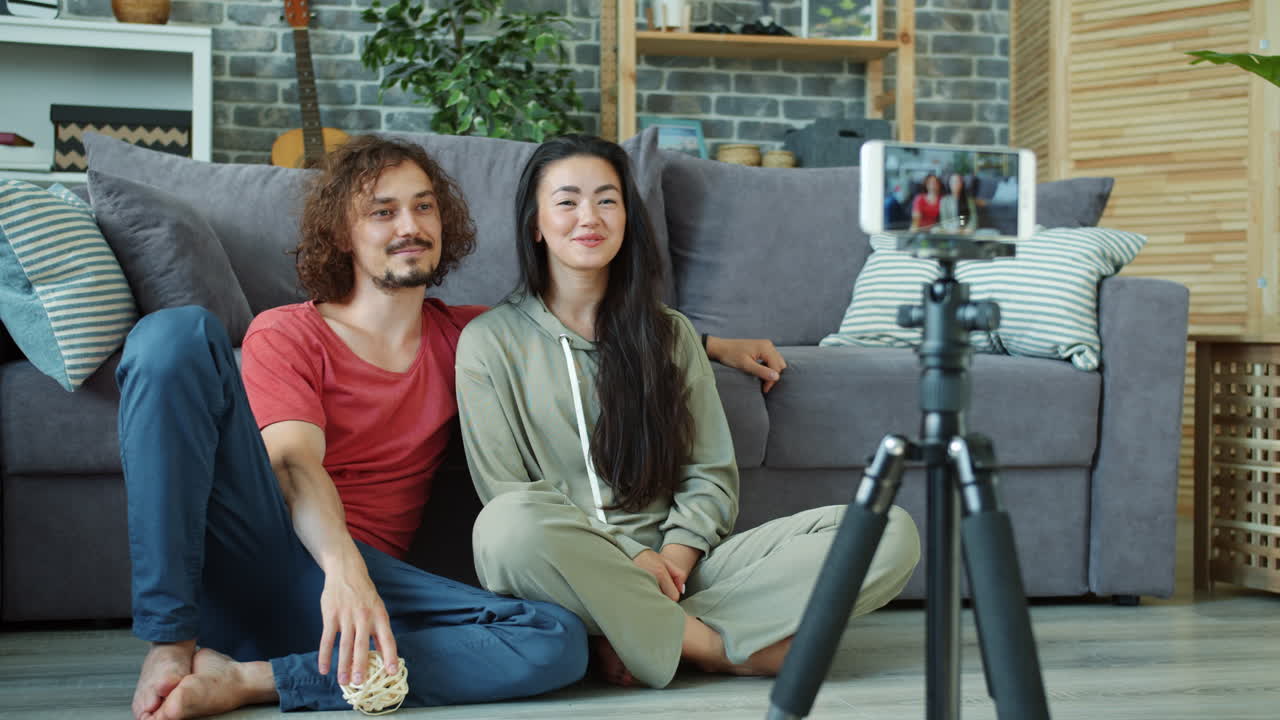 Couple making a video in their living room