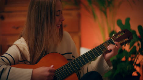 woman playing guitar writing song composing music