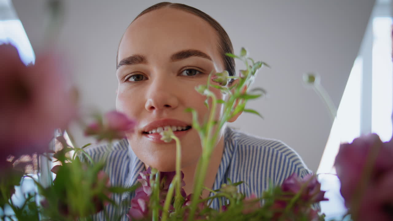 Carefree florist looking camera store portrait. Cute woman posing with bouquet
