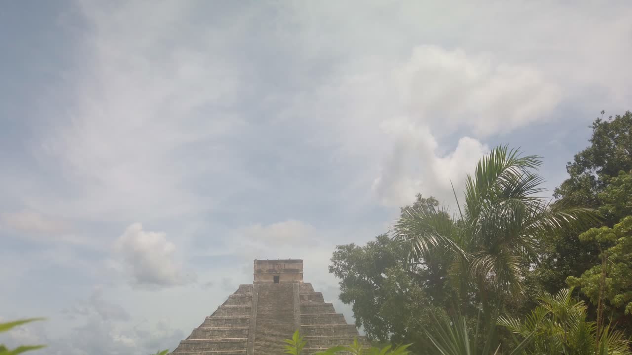 Gimbal wide booming down shot of the ancient Mayan pyramid El Castillo at Chichen Itza in Yucatan, Mexico. 4K