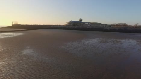 Aerial:-The-boulevard,-beach-and-city-of-Vlissingen-during-sunset