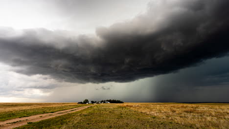 dark powerful storm clouds move over a small farm time lapse