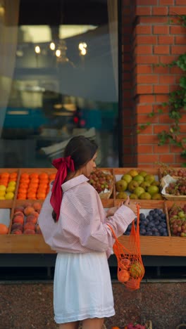 woman shopping for fruits at a grocery store