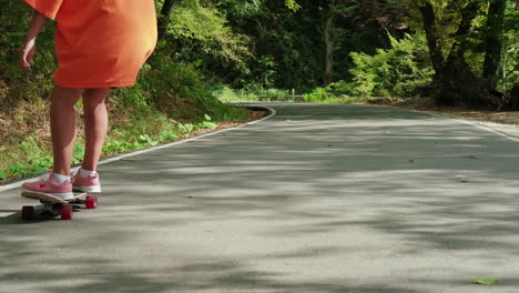 teenage girl skateboarding on a country road