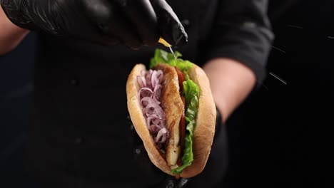 chef preparing a delicious fish sandwich