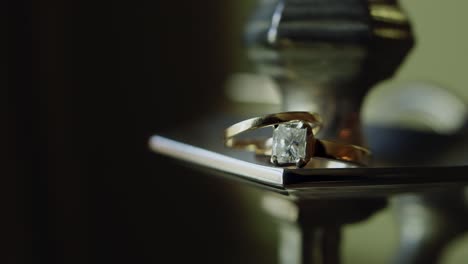 a slow pan of wedding rings staged in the glow of the afternoon sun