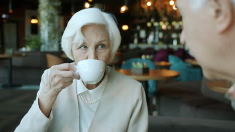 senior couple enjoying coffee in a cafe