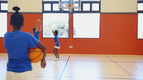 playing basketball in school gym, kids practicing dribbling and shooting skills
