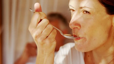 Couple-having-breakfast-and-cup-of-coffee-in-canopy-bed-4k