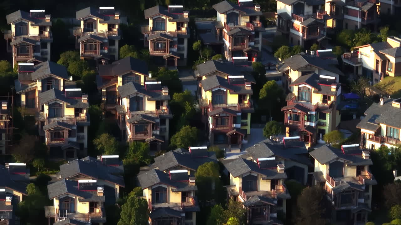 Telephoto aerial in front of similar neighborhood houses, golden hour in China