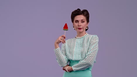 woman in retro attire licking a watermelon lollipop
