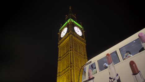 bus stopping in front of elizabeth tower at night