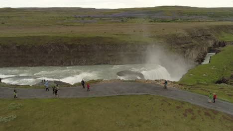 iceland waterfall, aerial view with tourists