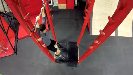 man performing monkey bar exercises in fitness gym 4k