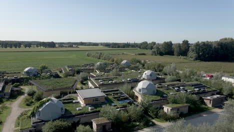 aerial view of an eco-community with dome houses and green roofs