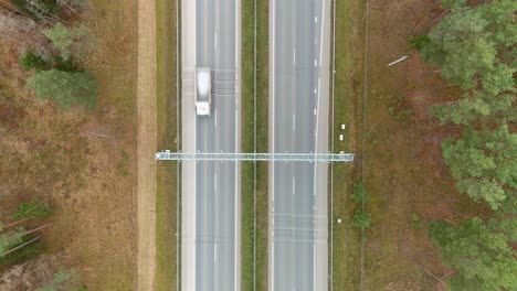 Speed-monitoring-equipment-over-highway-road,-aerial-top-down-view