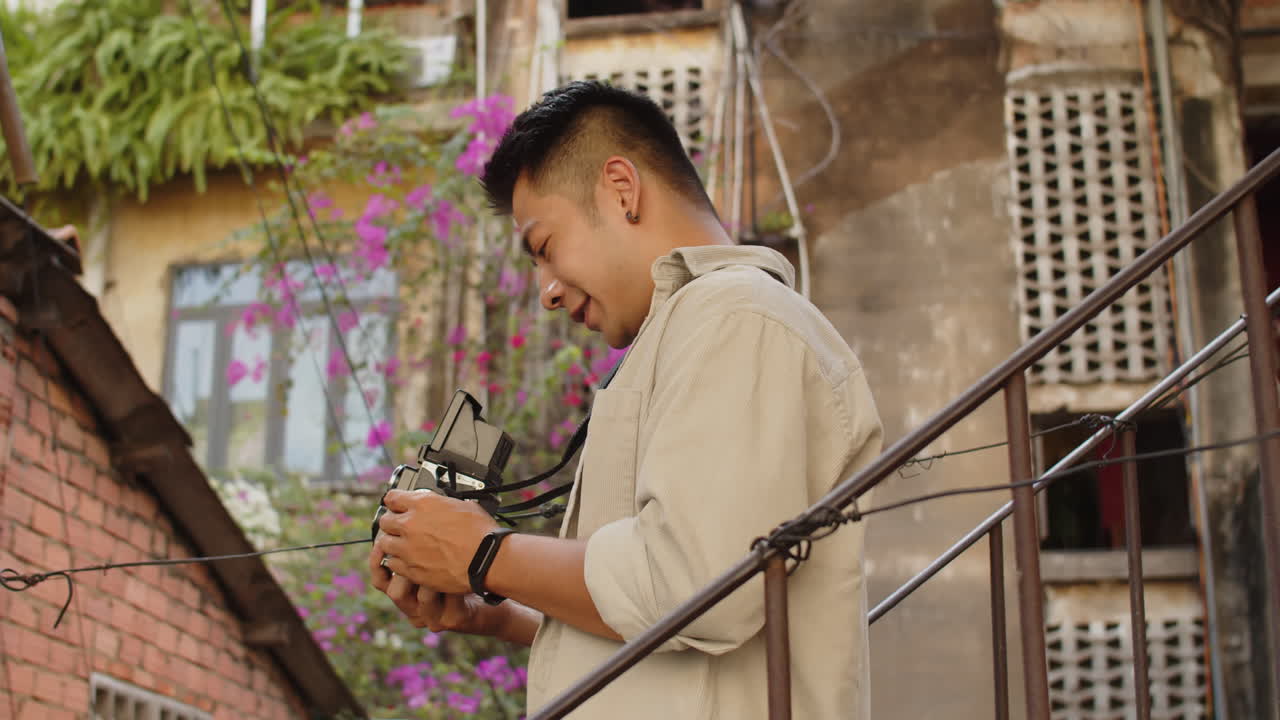 Portrait of Asian Photographer Taking Pictures of Abandoned House