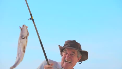 mature man catching a big fish