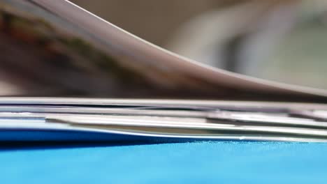 close-up of a stack of magazines on a blue surface