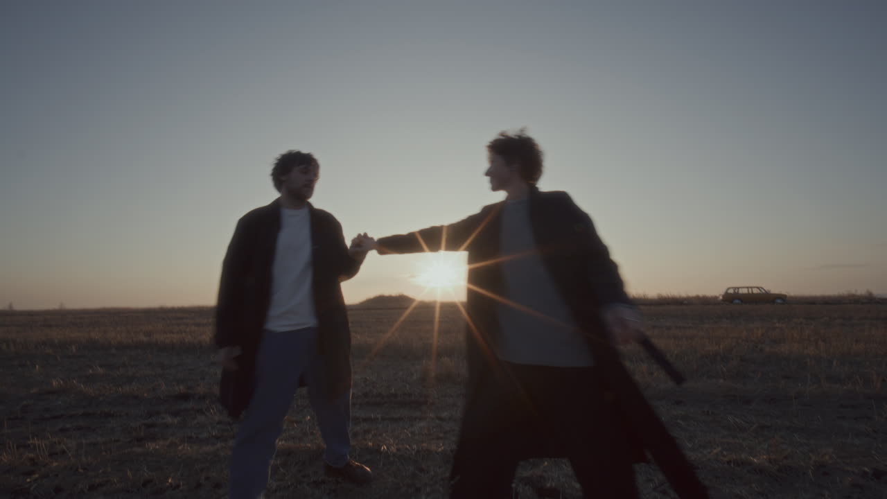 Loving Couple Spinning Together, Embracing and Having Fun in Open Field