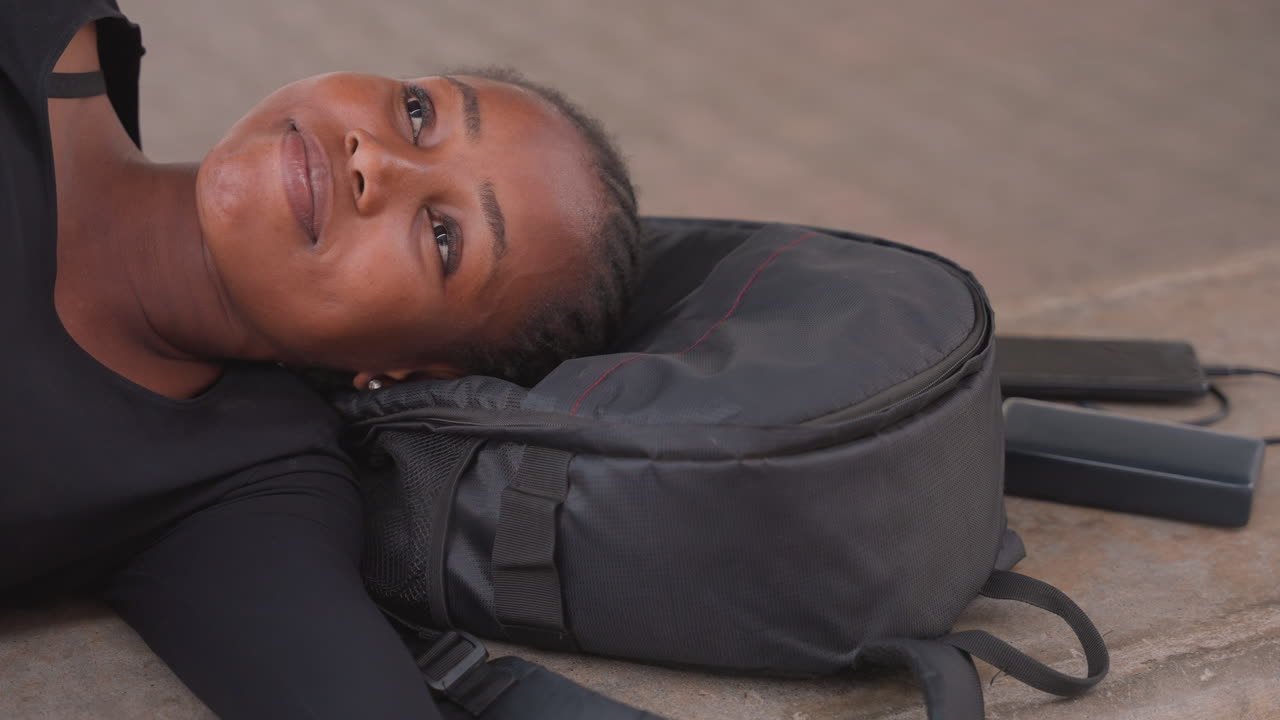 Traveler relaxes amid busy city. Serene individual enjoys peaceful outdoor setting amidst urban activity. Tranquil outdoor experience providing relaxation away from bustling city environment