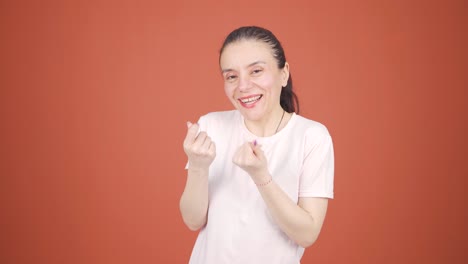 woman making money sign with her hands.