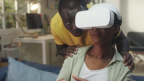 african american couple enjoying virtual reality gaming at home