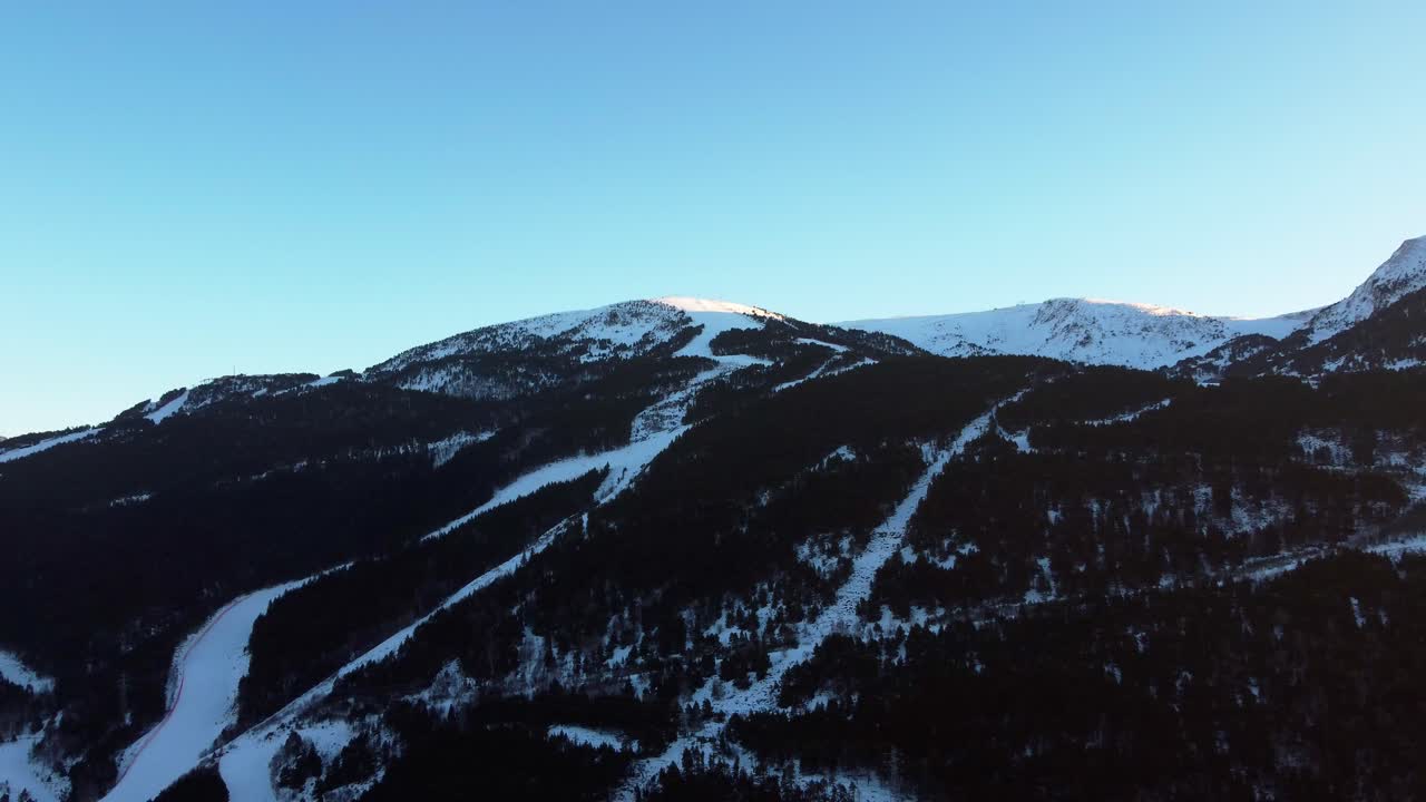4K Drone Flight Over Snowy Forested Mountains and Ski Trails in Andorra at Sunset