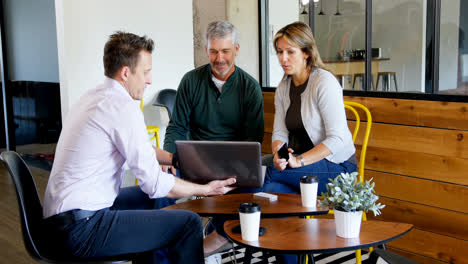 Executives-discussing-over-laptop-4k